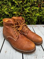 Three-quarter view of both boots showing leather uppers, laces, and soles