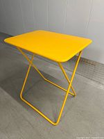 Full view of yellow square metal folding bistro table