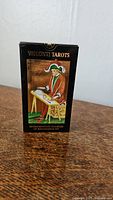 Closed box of Visconti-Sforza tarot deck featuring Renaissance artwork of a seated man at a table, labeled with deck name, showcasing box condition.