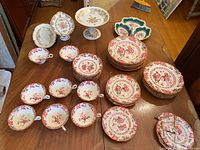 Wide top view showing tea cups, saucers, plates and bowls arranged on table