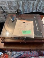 Overall view of the Dual 505-2 turntable with dust cover, cables and manual on top