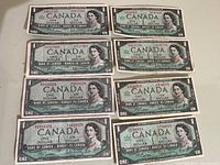 Top view of all eight 1954 Canadian one dollar bills laid out in two columns, showing front side with Queen Elizabeth II portraits, serial numbers, and signatures.