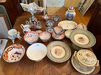Overview of all assorted china pieces arranged on table