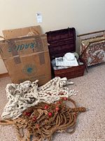 Overview of lot showing macrame hangers, sewing basket with yarn, sewing hamper, and cardboard box