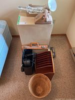 Full view of filing cabinet with items placed on top and in front, including the cedar organizer, paper shredder, waste basket, vintage rotary phone, and desk lamp.