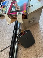 Kodak slide projector box, digital frame retail box, retractable tripod screen on carpet floor