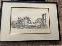 Black and white framed drawing of Wellington Front and Ontario Streets showing buildings and horse-drawn carriage.