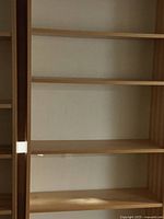 Close-up photo showing the shelves' height, width, and depth proportions with smooth light wood finish.