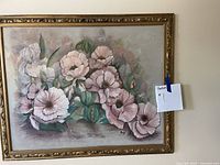 Frontal photo of original painting showing floral artwork and ornate gold frame, signed on lower right.