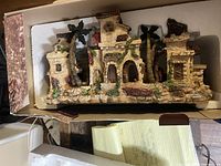 The nativity scene displayed in original box showing detailed buildings and palm trees.