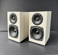 Pair of speakers angled front left on black background