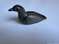 Side view of the soapstone loon sculpture, showing shape and polished surface.