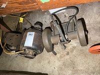 Photo of bench grinder motor and belt drive assembly showing condition and components