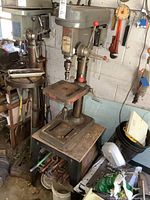 Side view of Gorilla bench top drill press with metal base and adjustable table, showing overall condition and configuration.