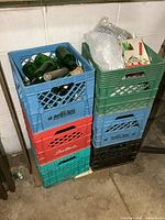 Stacked plastic milk crates with bottles and corks