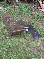 Overview of three live animal traps placed on grass outside, showing aged and weathered wire mesh construction, various sizes.