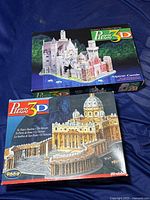 Photo showing both Wrebbit 3D puzzle boxes for Alpine Castle and St. Peter's Basilica.