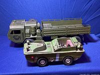 Side view of the amphibious troop carrier toy truck showing green body, detailed interior and realistic army vehicle design.
