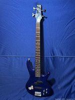 Full view of electric blue Ibanez Soundgear bass guitar showing body shape and color.