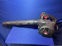 Full side view of the Murray gas blower showing the long blower tube and handle.