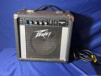 Front view of Peavey Audition 20 guitar amplifier against dark blue background, showing general exterior and control panel area.