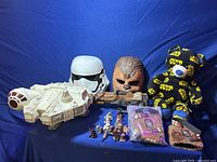 Full lot display showing masks, spaceship, speeder bike, can holders, character dolls and teddy bear