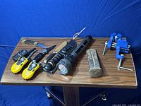 Wide view of lot items showing all tools on wooden table