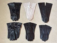 Overview of all 6 pairs of gloves laid out flat showing variety of styles and colors.