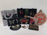 Group shot of all eight bags/purses and purse hanger against white background