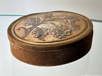 Overall view of oval velvet covered box with silver lid