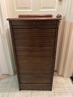 Full front view of closed tambour cabinet