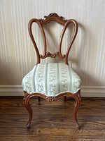 Full front view of chair showing frame and upholstered seat