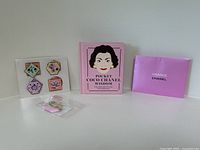 Full set with stickers sheet, pink Pocket Coco Chanel Wisdom book, and pink Chance Chanel envelope.