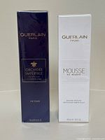 Front view of two boxed Guerlain Paris skincare products: Orchideé Impériale The Toner and Mousse de Beauté, both sealed.