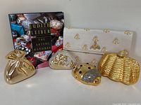 Book and five clutches arranged in a row on a neutral background