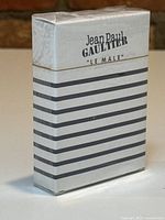 Front view of sealed Jean Paul Gaultier Le Male playing cards showing branding and striped design.