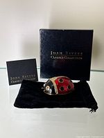 Black Joan Rivers Classics Collection box, black velvet pouch, and Joan Rivers ladybug trinket box with red and black enamel, gold-tone metal, and rhinestones