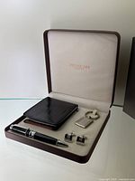 Full set in open brown presentation box showcasing wallet, pen, keychain, and cufflinks