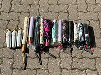 Overview of 17 assorted folding novelty umbrellas in various prints and handles