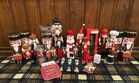 Full view of all nutcracker items arranged on patterned floor against wood panel wall