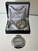 Both watches displayed; Philip Mercier in box with chain, Swiss Army in front
