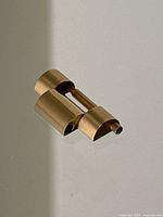 Front view of bracelet link and screw pin on reflective surface