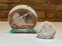 Both glass sculptures side by side showing size difference and bird details