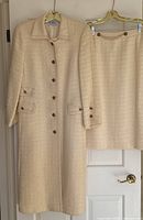 Full view of coat and skirt hanging side by side