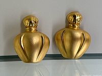 Front view of both earrings side by side showing bottle silhouette and finish