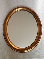 Front view of oval mirror on neutral surface