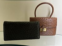 Green clutch and brown handbag displayed side by side