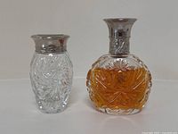 Overview of perfume bottle and vanity jar side by side on white background