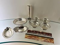 Wide shot of all lot items including dishes, bowls, toothpick holder, small dishes, and combs