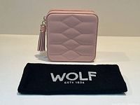 Closed case and black Wolf dust cloth branded “WOLF ESTD 1834”